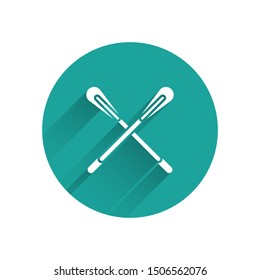 White Crossed paddle icon isolated with long shadow. Paddle boat oars. Green circle button. Vector Illustration