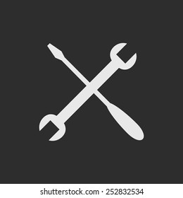 White crossed screw driver and spanner. Tools icon on dark grey background, repair symbol