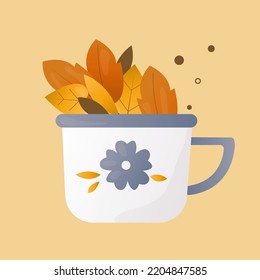 white cup with blue flowers decorated with autumn leaves