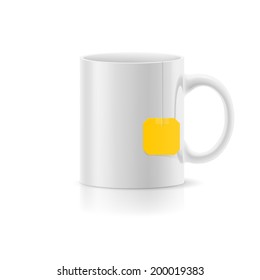 White cup with tea bag label from standing on white background