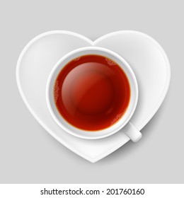 White cup of tea with saucer in shape of heart