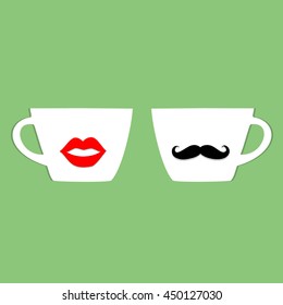 White cups with acrylic lips and moustache on green.