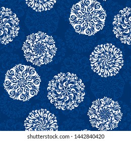 White curl snowflake winter seamless pattern. Classic floral style snow flakes repeatable motif on deep blue for fabric, surface design, background, web and print. Seasonal vector illustration.
