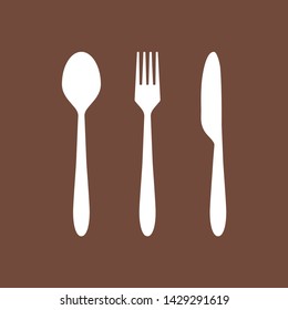 White cutlery and brown background