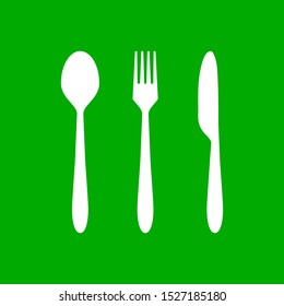 White cutlery and green background