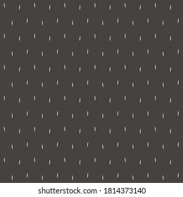White dashes on dark background. Black surface with short lines of variable thickness. Regular pattern.