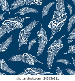 White decorative feathers over blue background