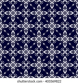 White decorative seamless texture on dark blue. Element for design. Ornamental backdrop. Ornate floral decor for wallpaper. Traditional decor on dark blue background.
