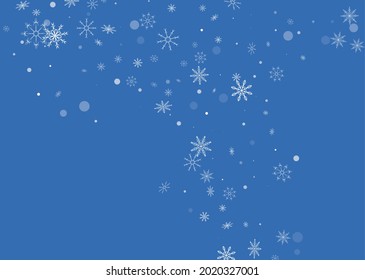 White delicate openwork snowflakes are scattered on a blue background. Festive background, postcard design, wallpaper
