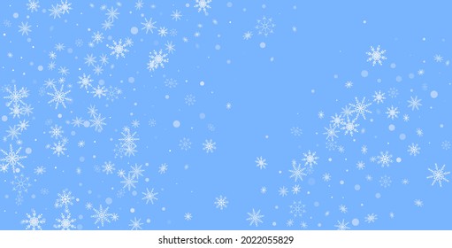 White delicate openwork snowflakes are scattered on a blue background. Festive background, postcard design, wallpaper