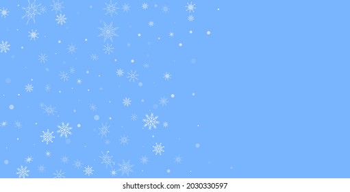 White delicate openwork snowflakes are scattered on a blue background. Festive background, postcard design, wallpaper