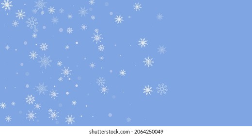 White delicate openwork snowflakes are scattered on a blue background. Festive background, postcard design, wallpaper