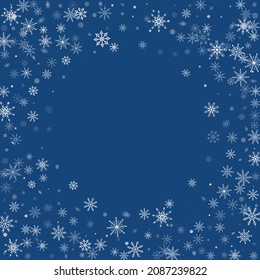 White delicate openwork snowflakes are scattered on a blue background. Festive background, postcard design, wallpaper
