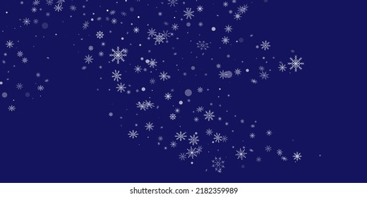 White delicate openwork snowflakes are scattered on a blue background. Festive background, postcard design, wallpaper