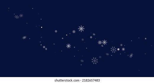 White delicate openwork snowflakes are scattered on a blue background. Festive background, postcard design, wallpaper