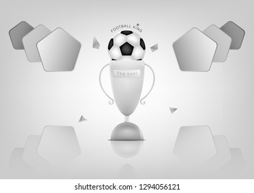 The white deserted cup with a soccer ball on the top and a pentagonal shape on both sides. With a gray polygon pattern around.