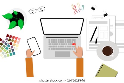 Un escritorio blanco con la mano utilizando un portátil y un teléfono inteligente para la idea de dibujo o dibujo. Concepto creativo.