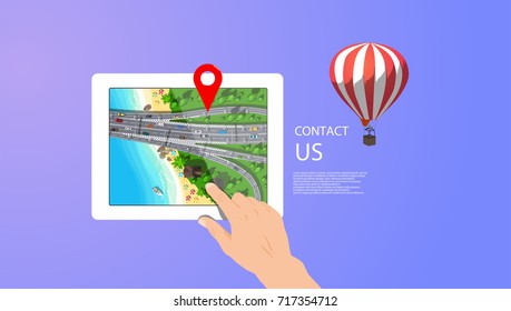 White digital tablet in hand with city map near blue sea with white boat