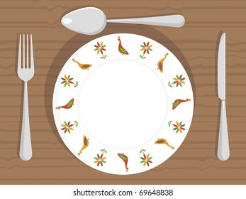 white dinner plate with peacock decorations and cutlery