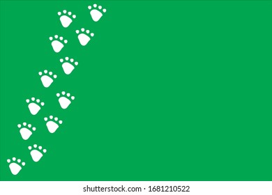 White dog or cat pet footprint tracks on bright green background. Animal and pet concept.