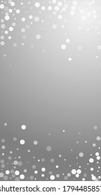 White dots Christmas background. Subtle flying snow flakes and stars on grey background. Alluring winter silver snowflake overlay template. Quaint vertical illustration.