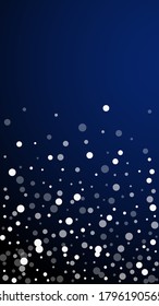 White dots Christmas background. Subtle flying snow flakes and stars on dark blue background. Amusing winter silver snowflake overlay template. Emotional vertical illustration.