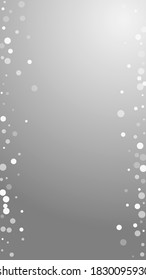 White dots Christmas background. Subtle flying snow flakes and stars on grey background. Adorable winter silver snowflake overlay template. Classic vertical illustration.