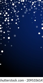 White dots Christmas background. Subtle flying snow flakes and stars on dark blue background. Alluring winter silver snowflake overlay template. Bizarre vertical illustration.