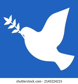 White dove flying on blue sky. Peace bird holding Mira branch.