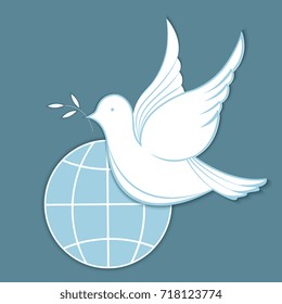 White dove with an olive branch against the background of the globe. Concept for the Day of Peace.