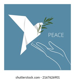 A white dove of peace with an olive branch flies into the palm of your hand. A symbol of peace. Origami for the International Day of Peace