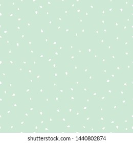 White drops on a mint background.