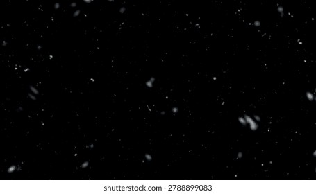 White dust particles floating on a solid black background
