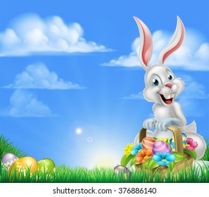 White Easter bunny with a basket full of decorated chocolate Easter eggs in a field 