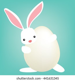 white easter bunny hiding behind egg