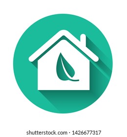 White Eco friendly house icon isolated with long shadow. Eco house with leaf. Green circle button. Vector Illustration