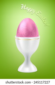 White egg in cup with golden stripe. Easter breakfast food. Green background.