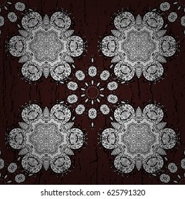 White element on brown background. Damask seamless pattern repeating background. Antique white repeatable wallpaper. White floral ornament in baroque style.