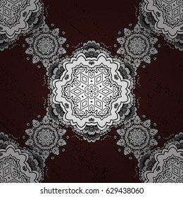 White element on brown background. Antique white repeatable wallpaper. White floral ornament in baroque style. Damask seamless pattern repeating background.
