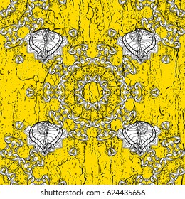 White element on yellow background. Gray Wallpaper on texture background.Damask pattern repeating background. Gray yellow floral ornament in baroque style.