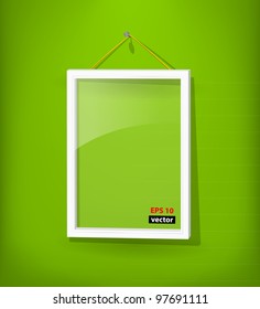 White empty frame with glass hang on the green wall. Eps10. Used opacity layers for effects shadow and glass reflection