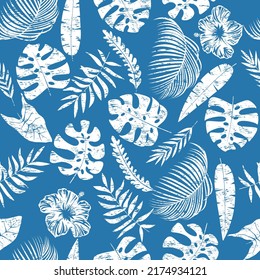 White exotic leaves with flowers hibiscus on blue background. Print with scuffs