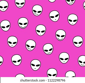 White faces of aliens on a bright pink field. 