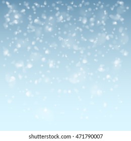 White falling flakes of snow on light blue