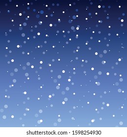 white falling snow against a beautifully colored gradient blue sky in the winter season before Christmas