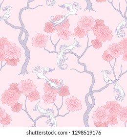 White fantasy birds in sakura garden on pink background. Elegant seamless pattern for textile design and decoration
