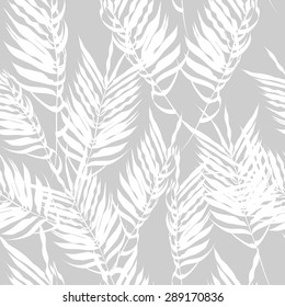 White fern leaves on a gray background. Seamless pattern. modern palm leaves