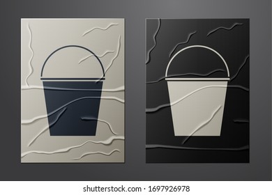 White Fire bucket icon isolated on crumpled paper background. Metal bucket empty or with water for fire fighting. Paper art style. Vector Illustration