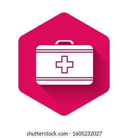 White First aid kit icon isolated with long shadow. Medical box with cross. Medical equipment for emergency. Healthcare concept. Pink hexagon button. Vector Illustration