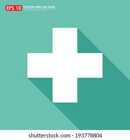 White first aid sign with shadow on light green background